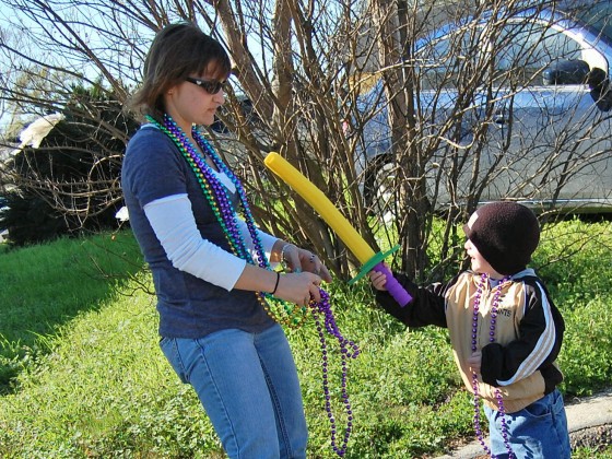 Kid points foam sword at mom